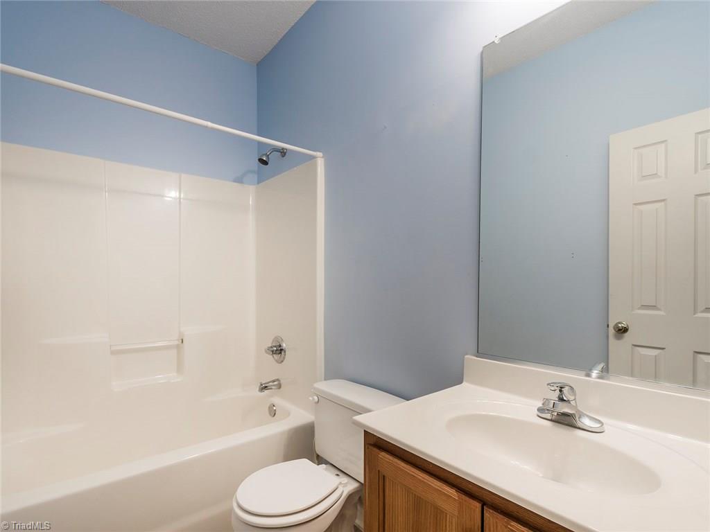 4705 Fewell Road Greensboro, NC 27405 - Photo 15 of 23 The full bath is located between the two guest rooms with easy access to the living room. It offers a shower/tub combo.