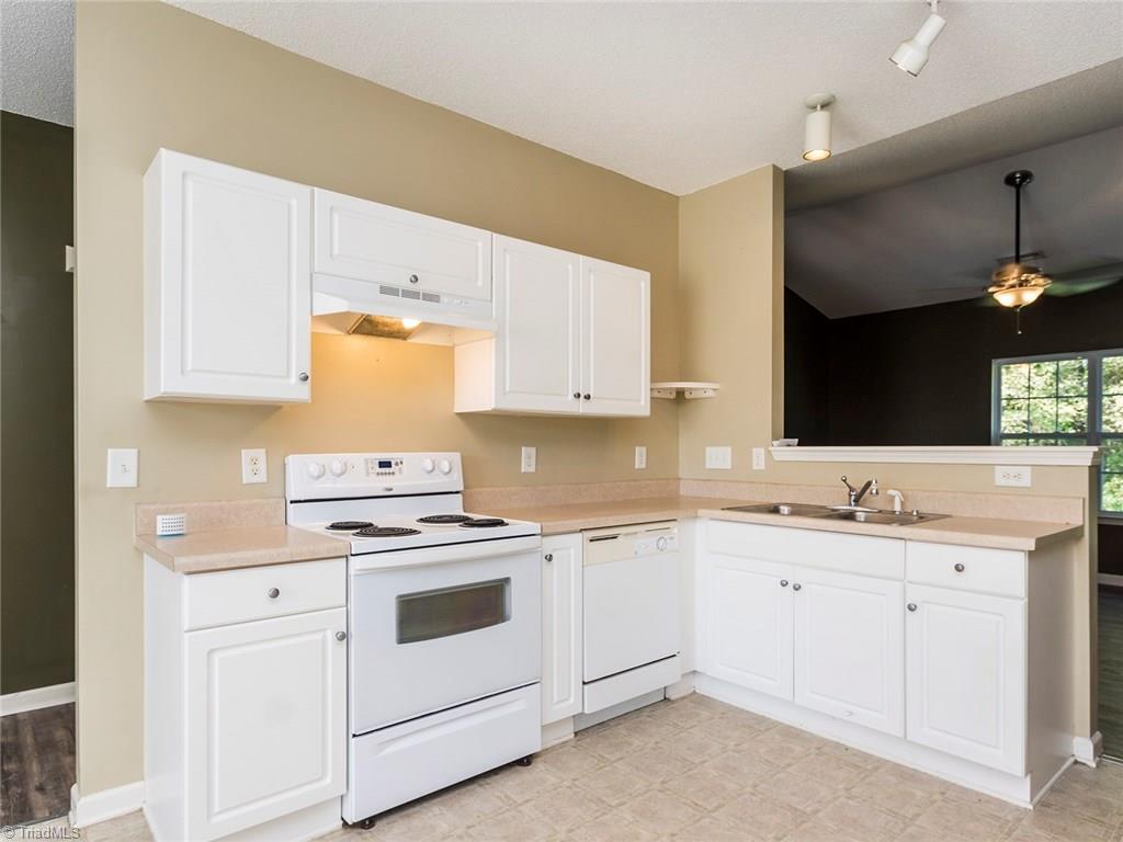 4705 Fewell Road Greensboro, NC 27405 - Photo 5 of 23 The kitchen offers great counter space and cabinet space. It opens to the Living room creating a wonderful open feel. see the private backyard while your cooking