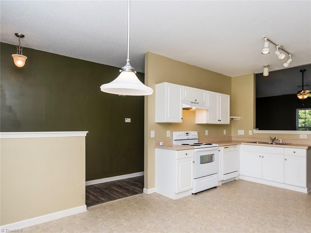 4705 Fewell Road Greensboro, NC 27405 - Photo 23 of 23 The open floor plan shows that the living room is open to the kitchen and dining room.