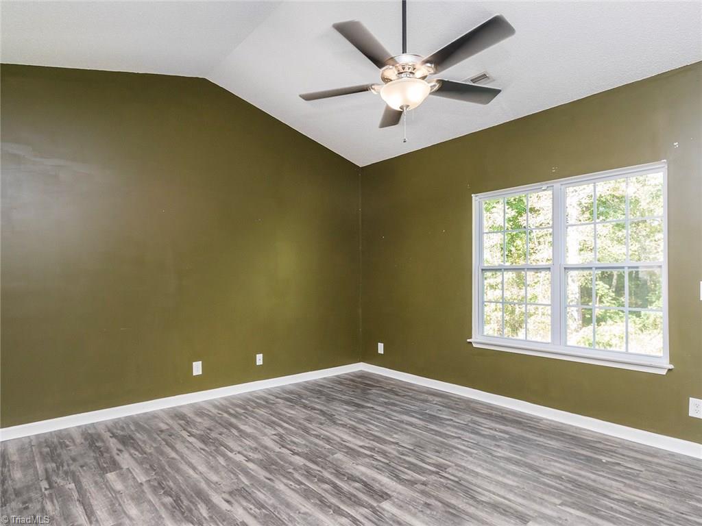 4705 Fewell Road Greensboro, NC 27405 - Photo 8 of 23 The living room overlooks the backyard and offers a great space for entertaining.