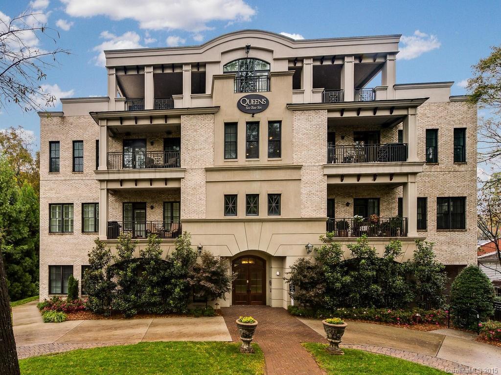 626 Queens Road, Unit 304 Charlotte, NC 28207 - Photo 2 of 24 a front view of a residential apartment building with a yard