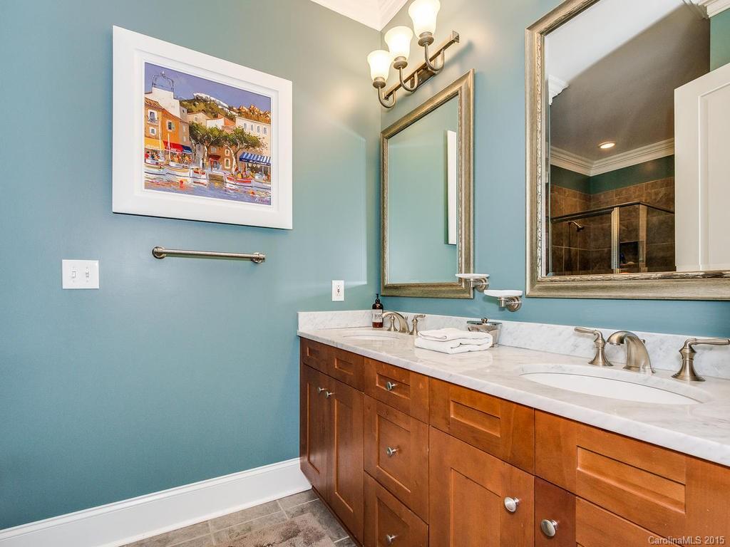 626 Queens Road, Unit 304 Charlotte, NC 28207 - Photo 11 of 24 a bathroom with a double vanity sink and a mirror