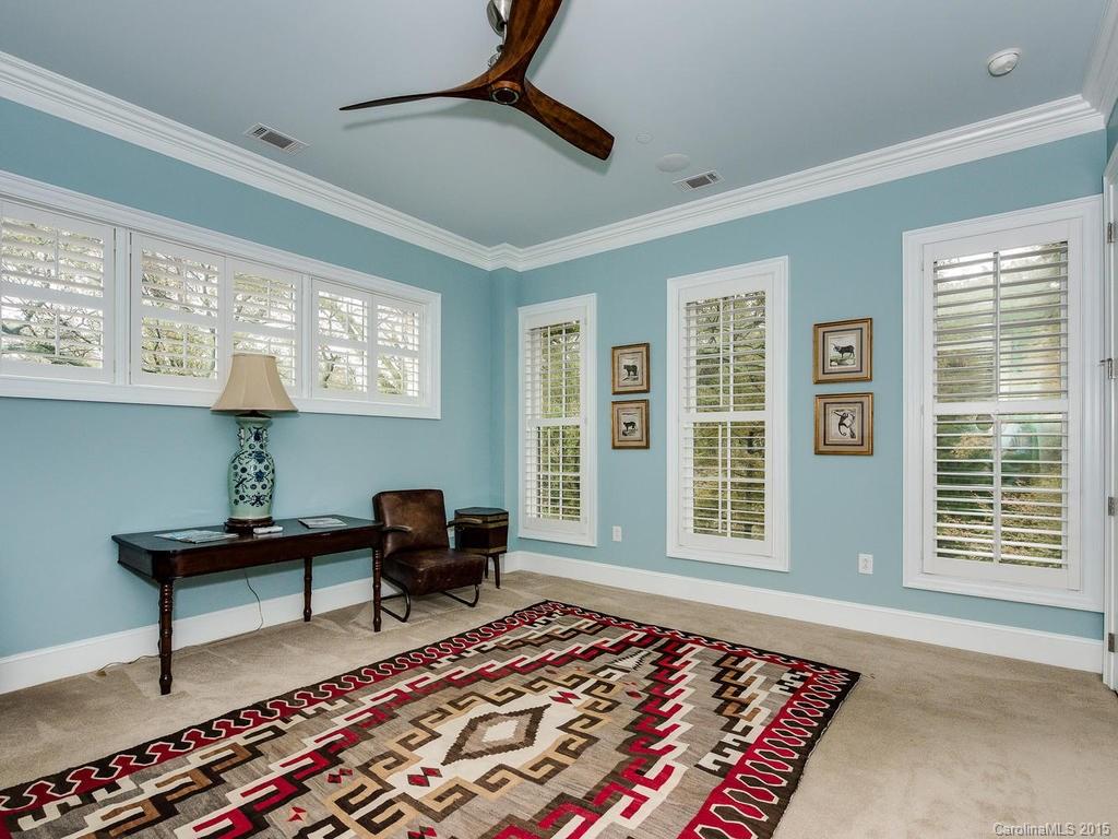 626 Queens Road, Unit 304 Charlotte, NC 28207 - Photo 12 of 24 a living room with furniture and a rug