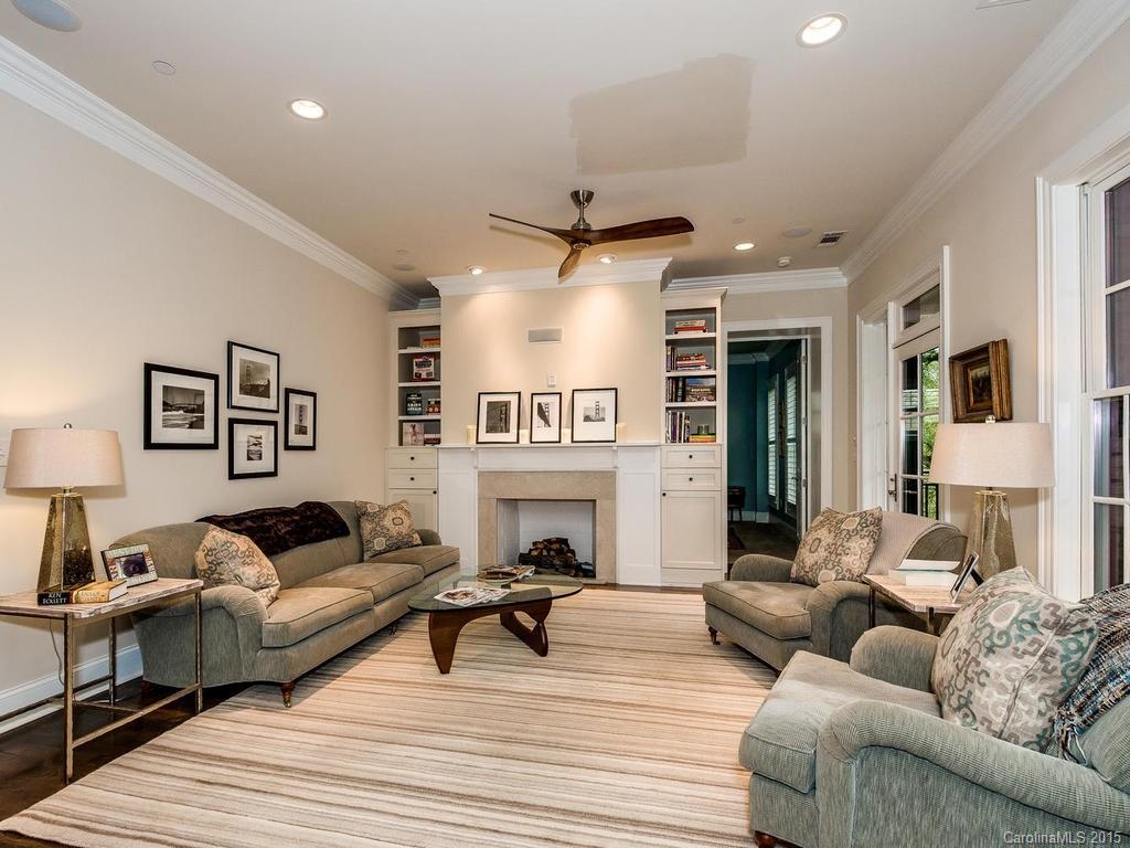 626 Queens Road, Unit 304 Charlotte, NC 28207 - Photo 9 of 24 a living room with furniture a fireplace and a flat screen tv