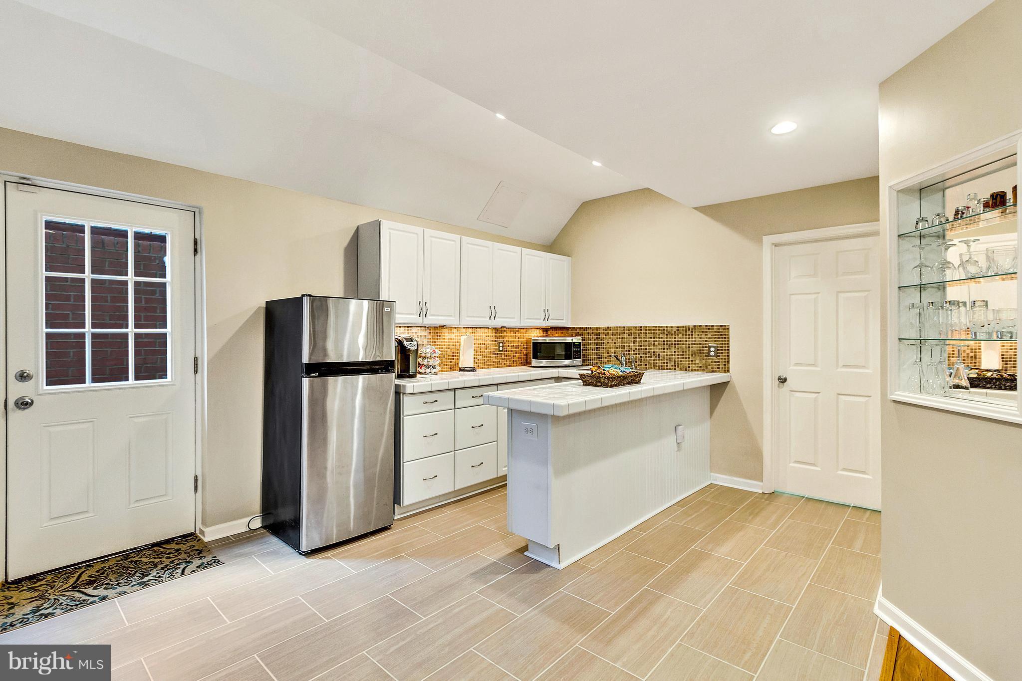 8040 Stillbrooke Road Manassas, VA 20112 - Photo 22 of 29 LL Wet Bar w/Fridge, Sink, Breakfast Bar, Tile