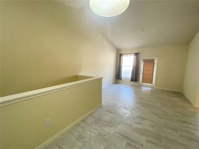 a view of a room with wooden floor