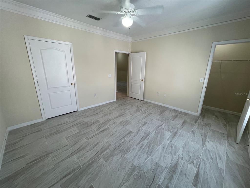 18108 Villa Creek Drive Tampa, FL 33647 - Photo 23 of 25 wooden floor in an empty room with a window