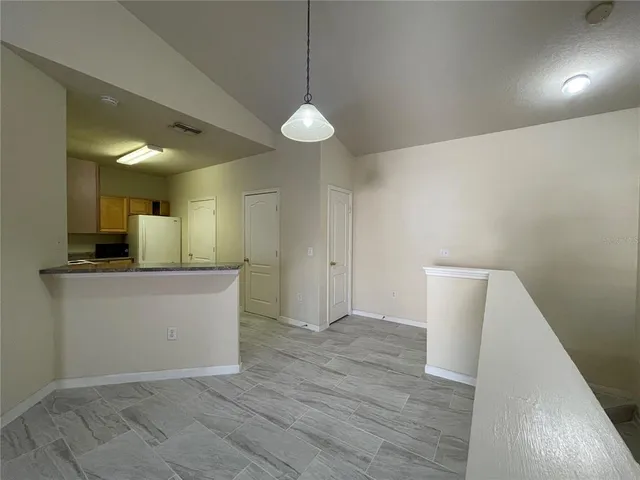a view of a kitchen with kitchen island wooden floor and window