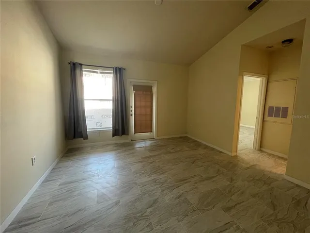an empty room with windows and entrance