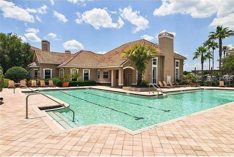 18108 Villa Creek Drive Tampa, FL 33647 - Photo 5 of 25 a view of a white house with a yard table and chairs