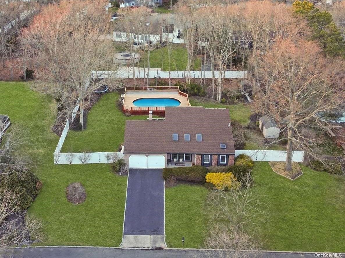 a aerial view of a house with garden space and street view