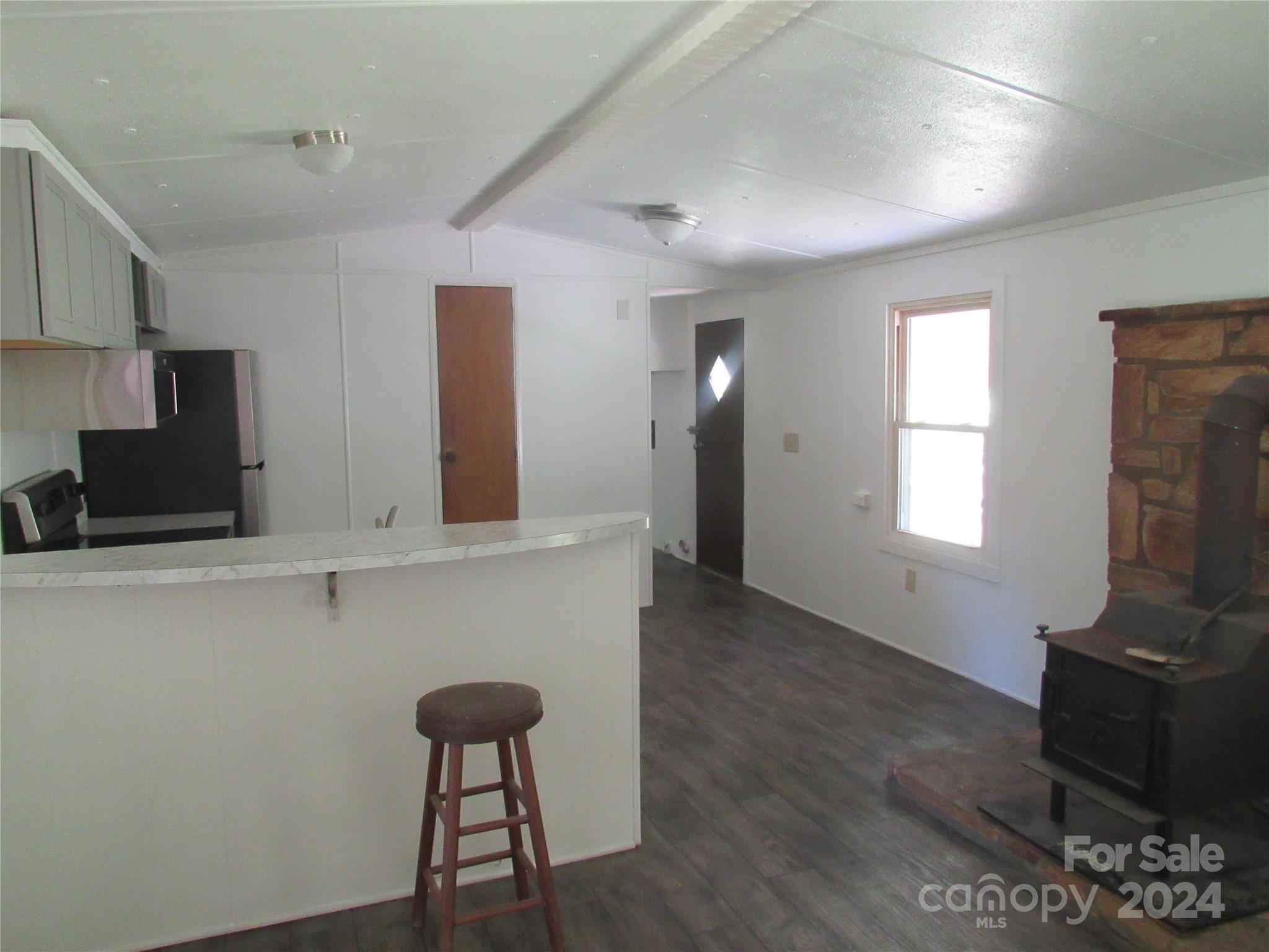 664 Woodfin Road Sylva, NC 28779 - Photo 11 of 34 a living room with furniture and a flat screen tv