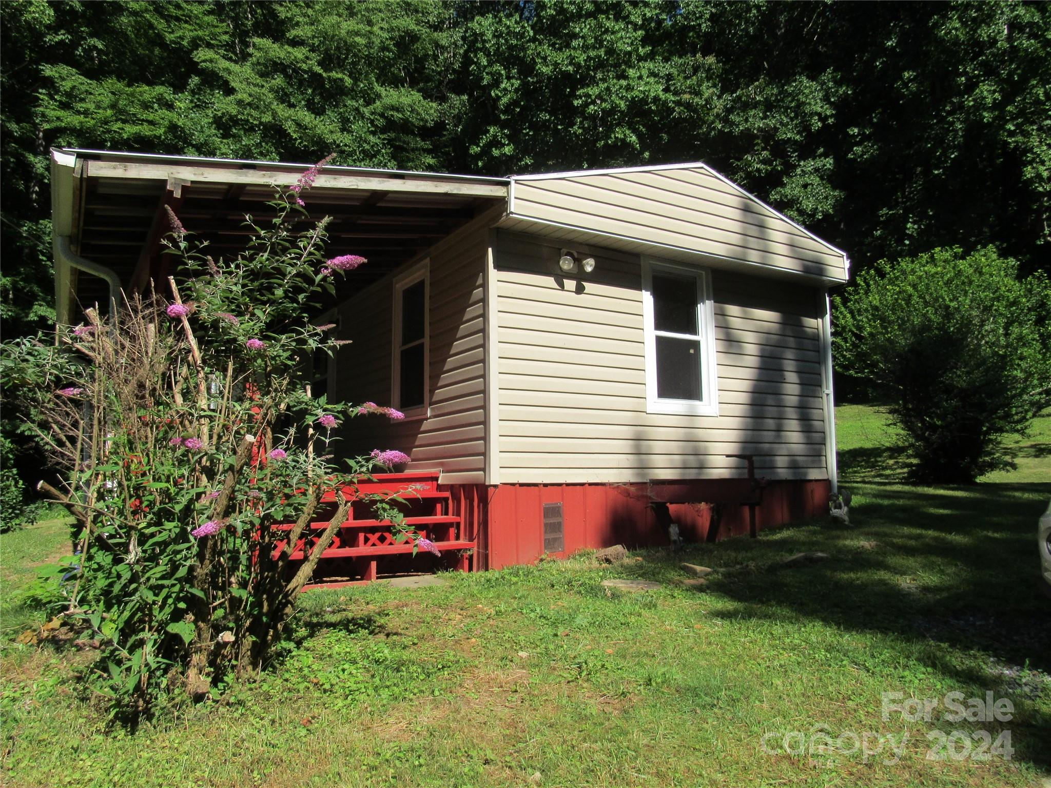 664 Woodfin Road Sylva, NC 28779 - Photo 13 of 34 a view of house with a yard and sitting area