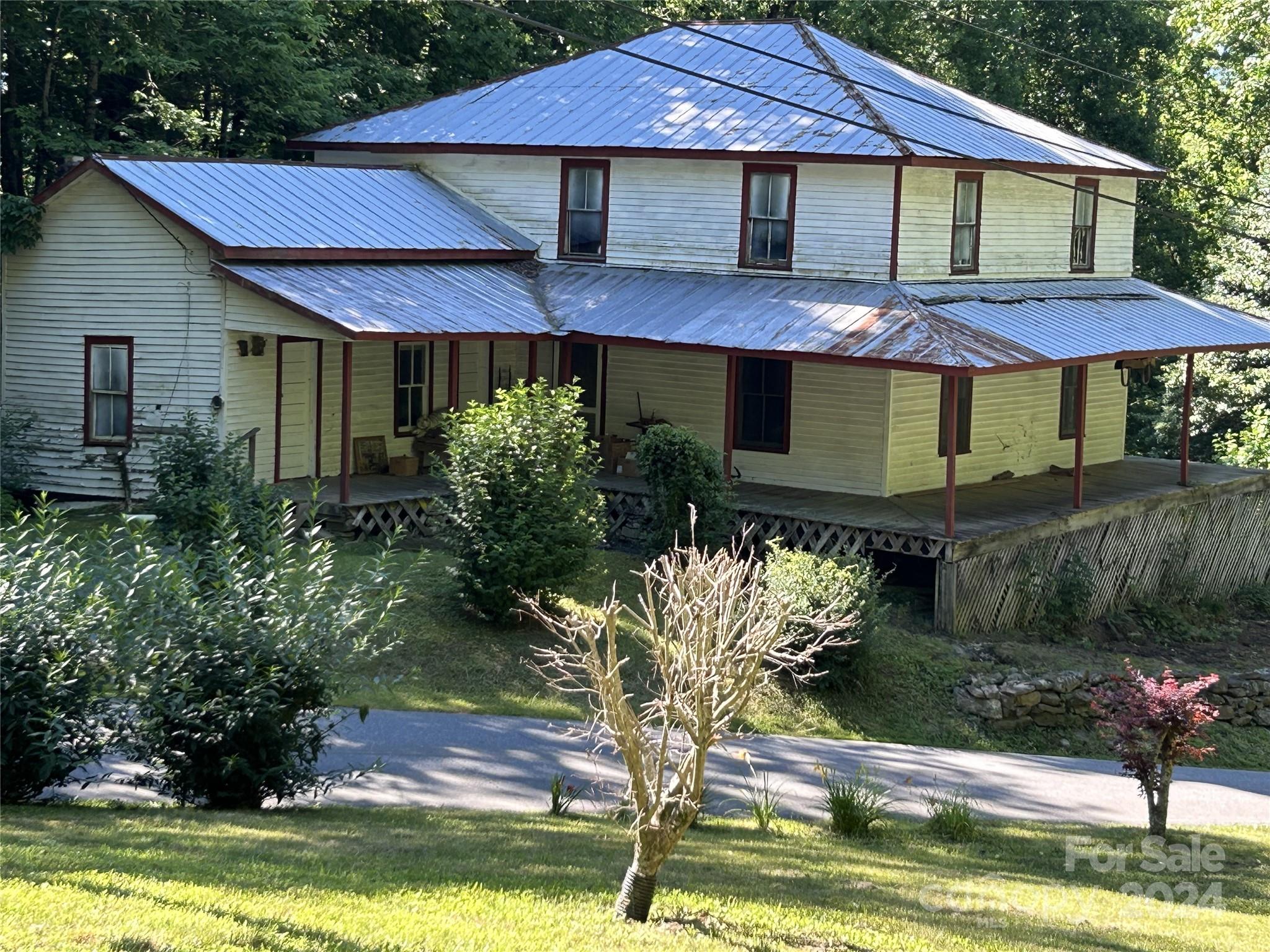 664 Woodfin Road Sylva, NC 28779 - Photo 17 of 34 a front view of a house with a yard and porch