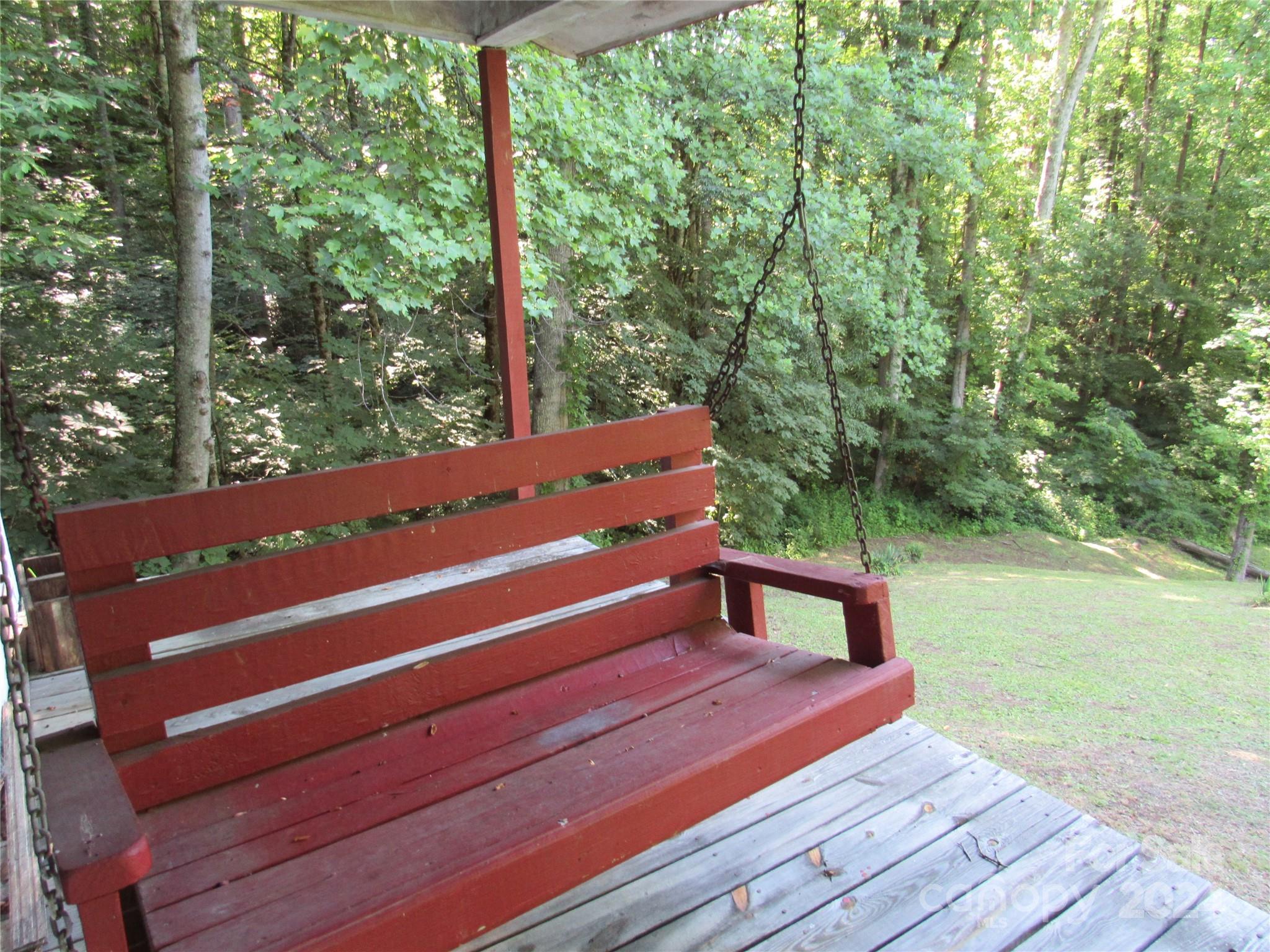 664 Woodfin Road Sylva, NC 28779 - Photo 19 of 34 a view of a wooden deck with a yard