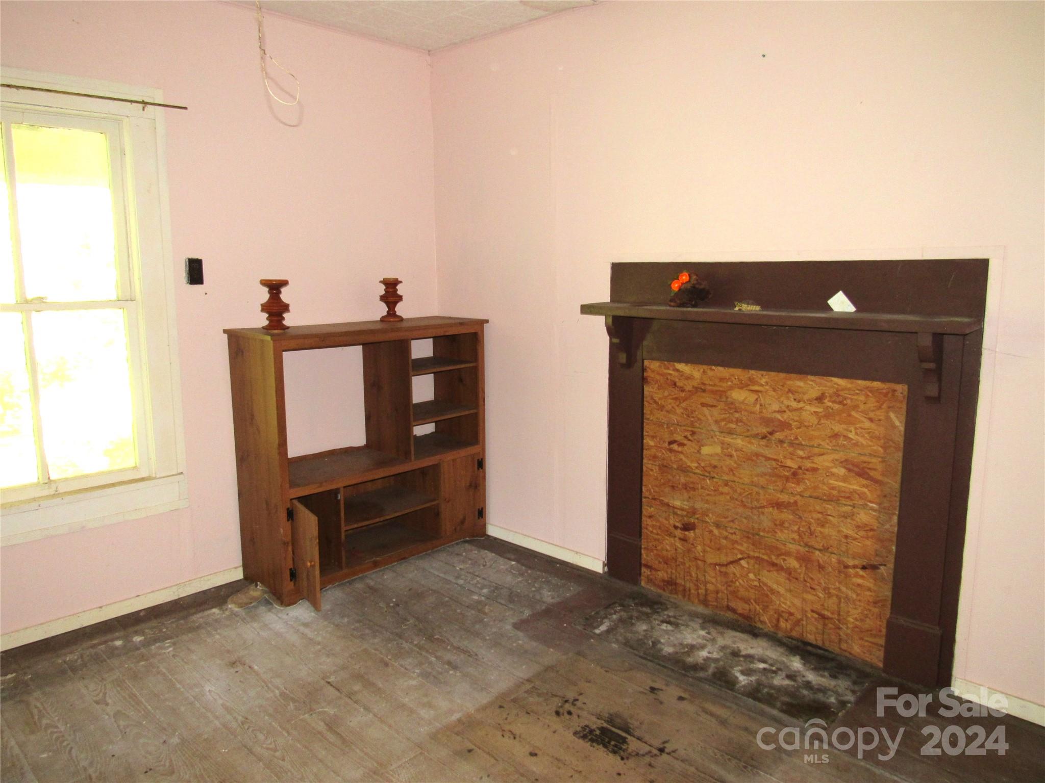 664 Woodfin Road Sylva, NC 28779 - Photo 22 of 34 an empty room with windows and cabinet