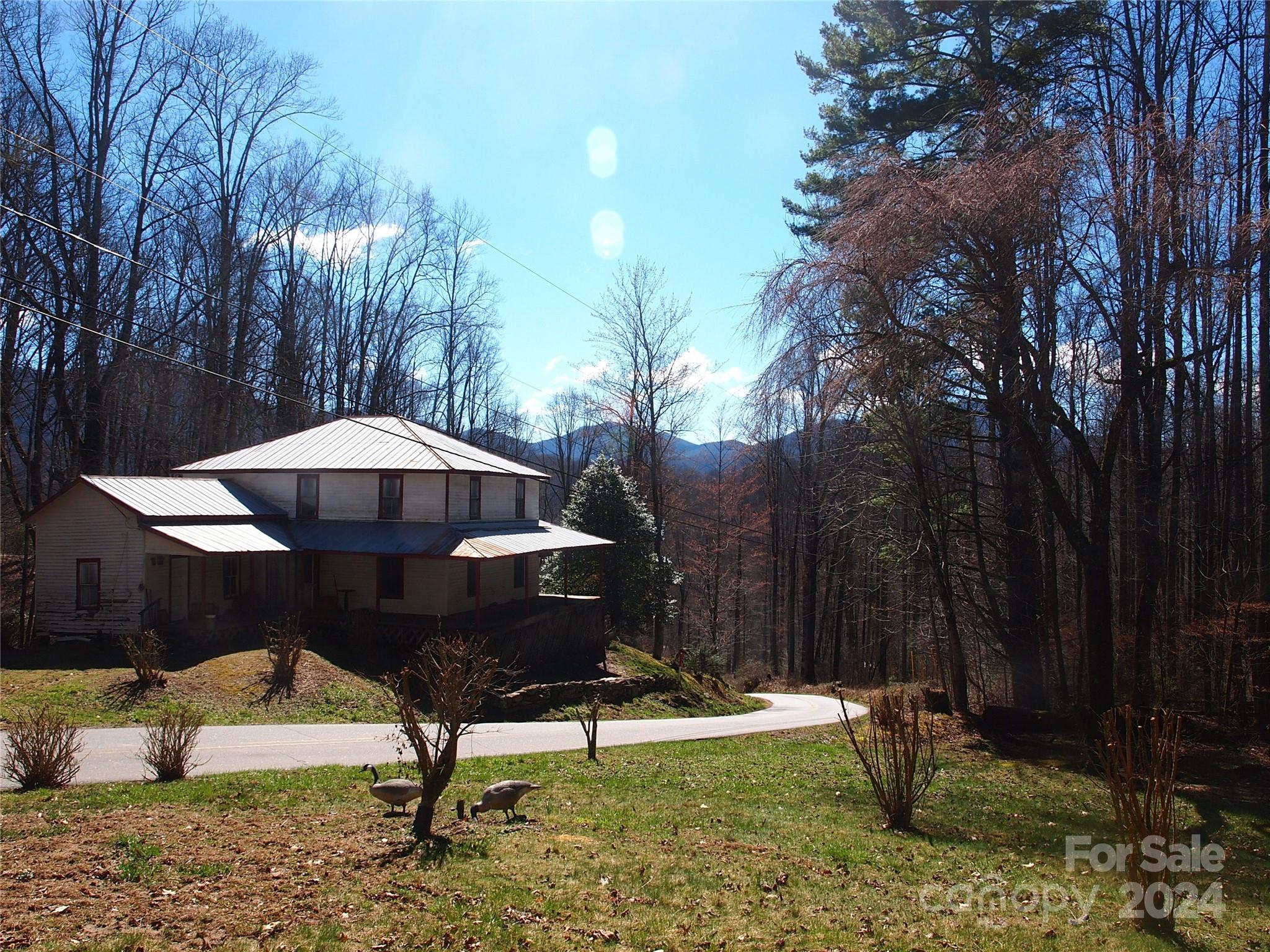 664 Woodfin Road Sylva, NC 28779 - Photo 32 of 34 a swimming pool with outdoor seating and trees
