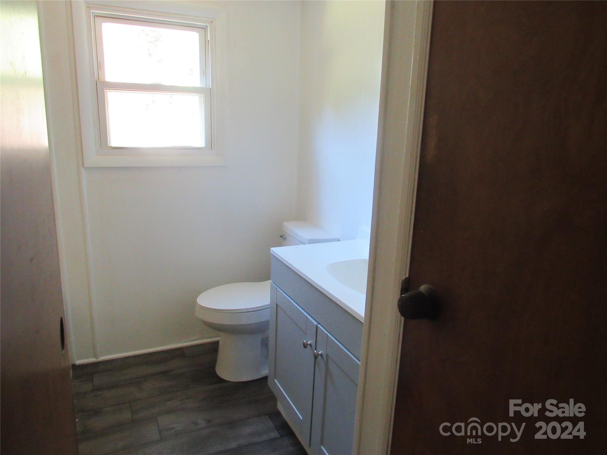 664 Woodfin Road Sylva, NC 28779 - Photo 7 of 34 a bathroom with a toilet and a window