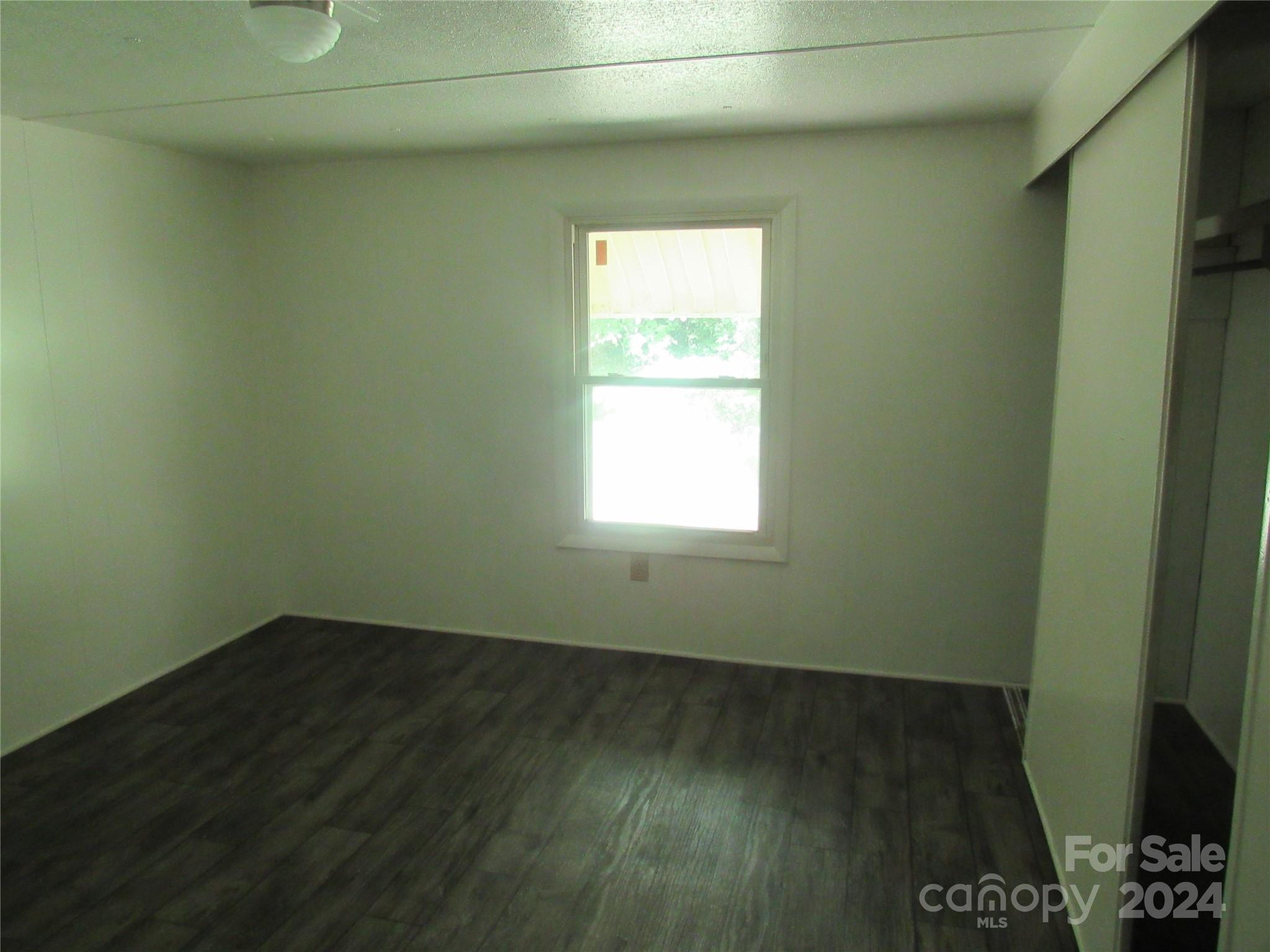 664 Woodfin Road Sylva, NC 28779 - Photo 8 of 34 a view of a room that has wooden floor and a window