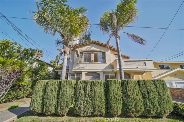 a front view of a residential apartment building with a yard