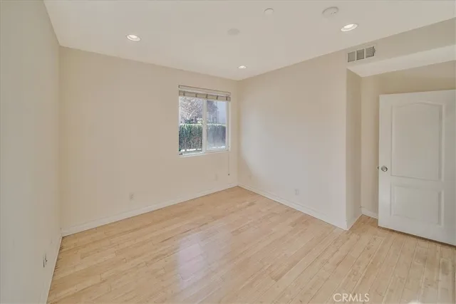 a spacious bathroom with a granite countertop sink a toilet and a mirror