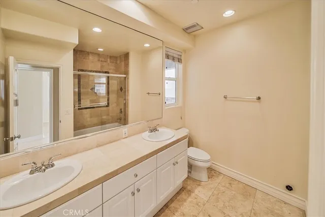 a bathroom with a double vanity sink mirror and