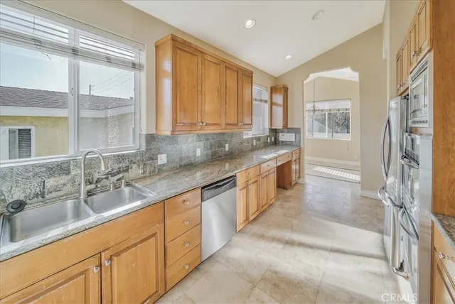 a view of a hallway with wooden floor and dining room