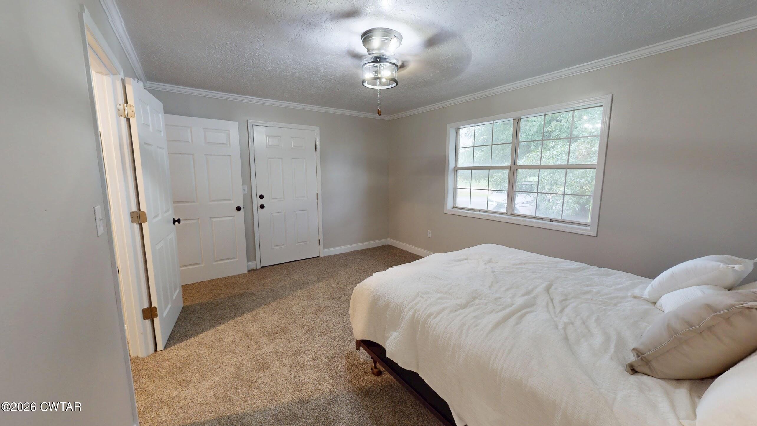 2800 Locust Grove Road Newbern, TN 38059 - Photo 32 of 46 a bedroom with a bed and a chandelier