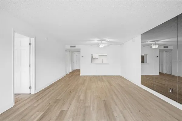 a view of empty room with wooden floor