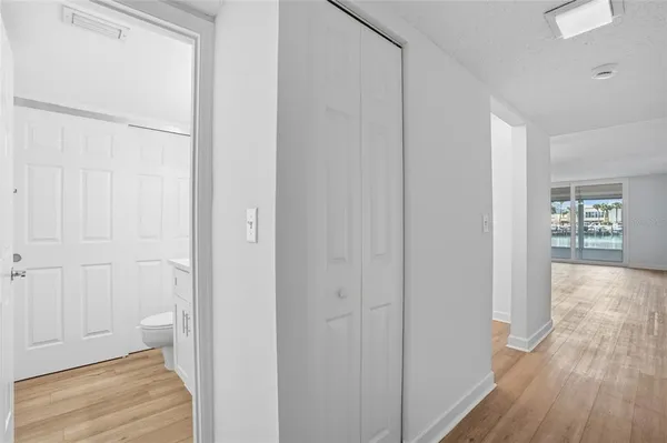 a view of a hallway with wooden floor