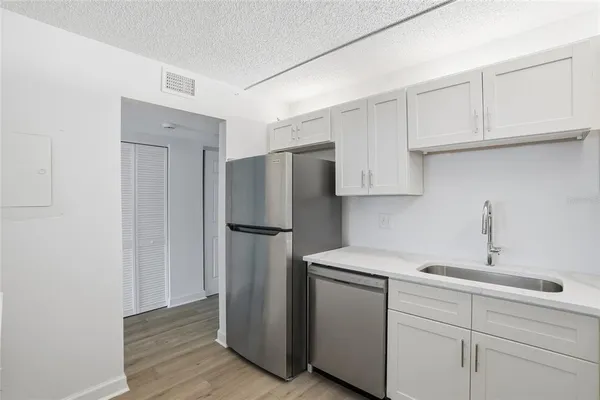 a kitchen with cabinets and stainless steel appliances