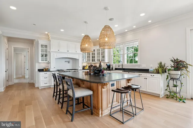 a living room with furniture and a large window with wooden floor