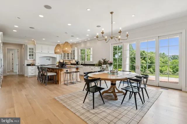 a living room with furniture a large window and a fireplace