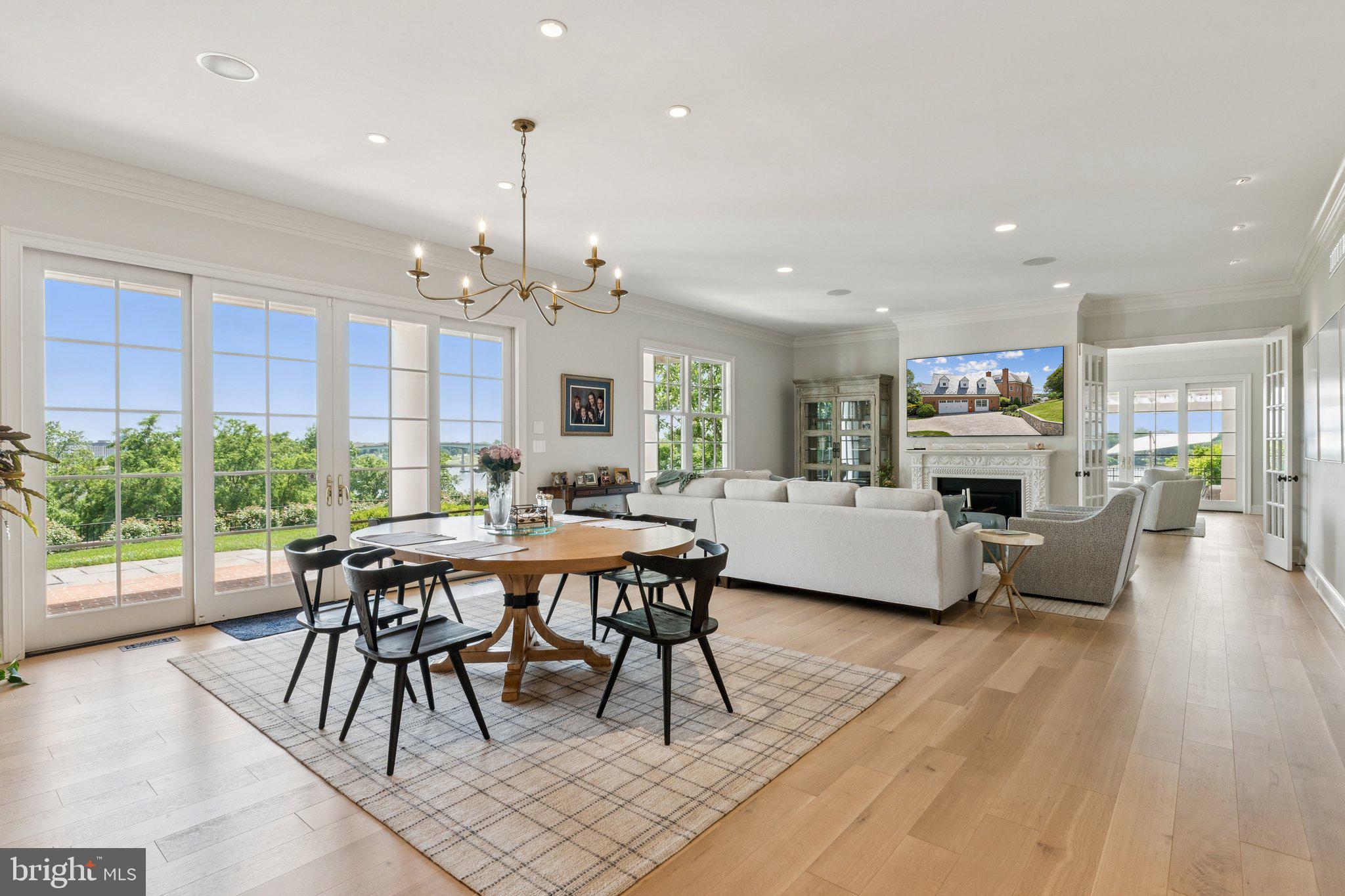 1932 Carrollton Road Annapolis, MD 21409 - Photo 16 of 85 a living room with furniture a fireplace and a dining table with wooden floor