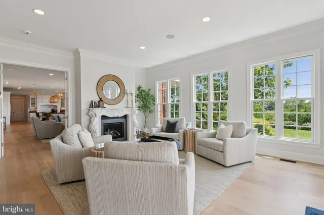 a living room with furniture a wooden floor and a chandelier