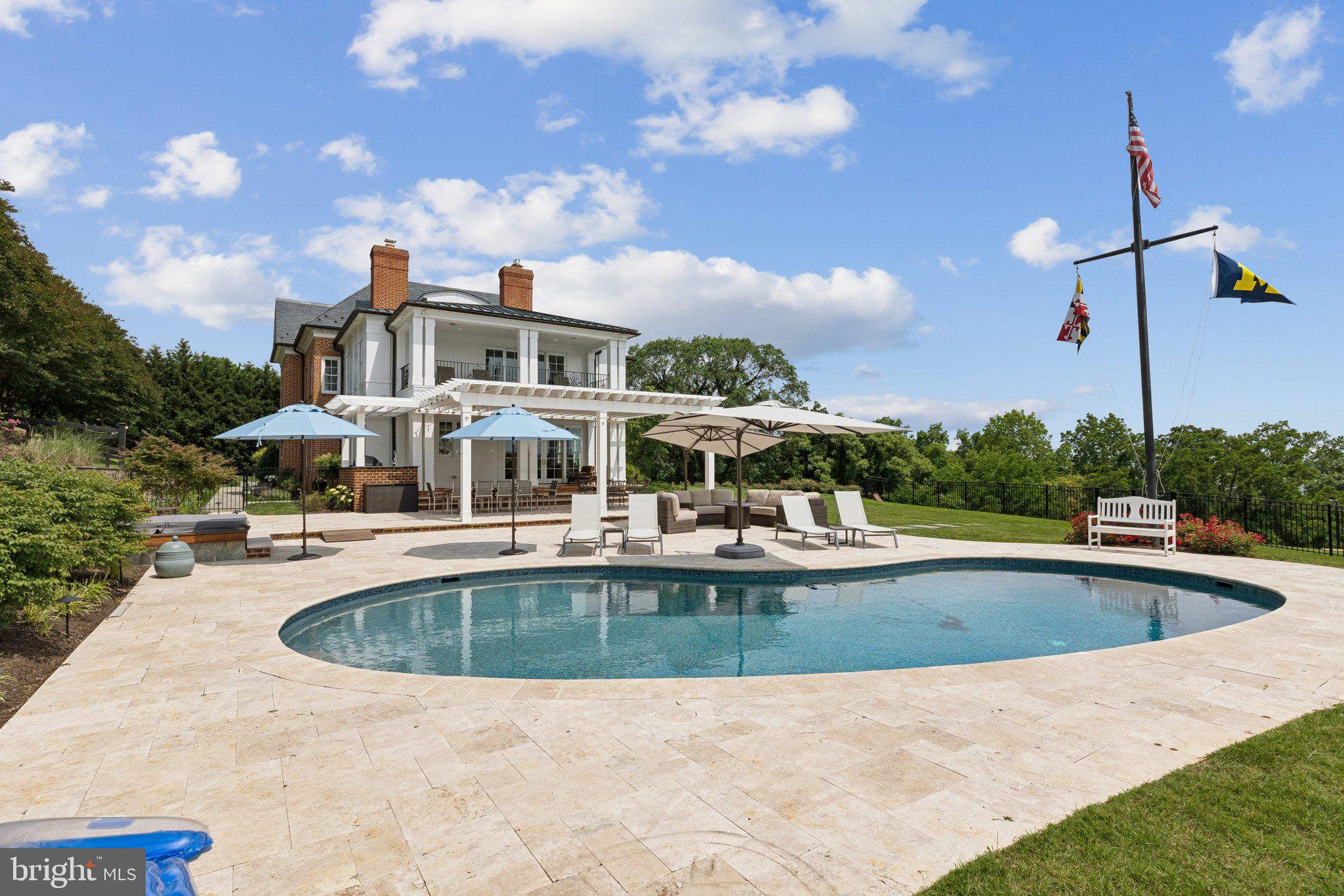 1932 Carrollton Road Annapolis, MD 21409 - Photo 25 of 85 a view of a swimming pool with a table and chairs