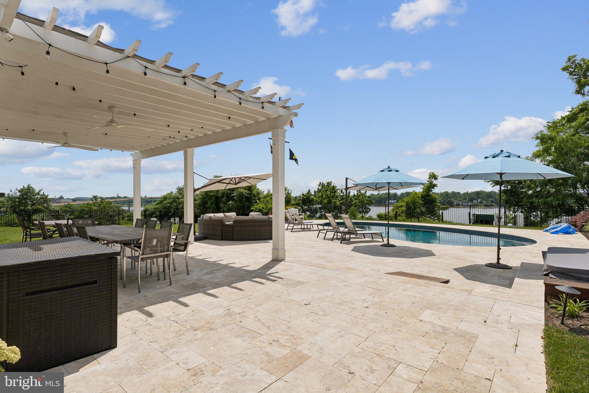 1932 Carrollton Road Annapolis, MD 21409 - Photo 26 of 85 a view of a patio with a table and chairs under an umbrella with a patio