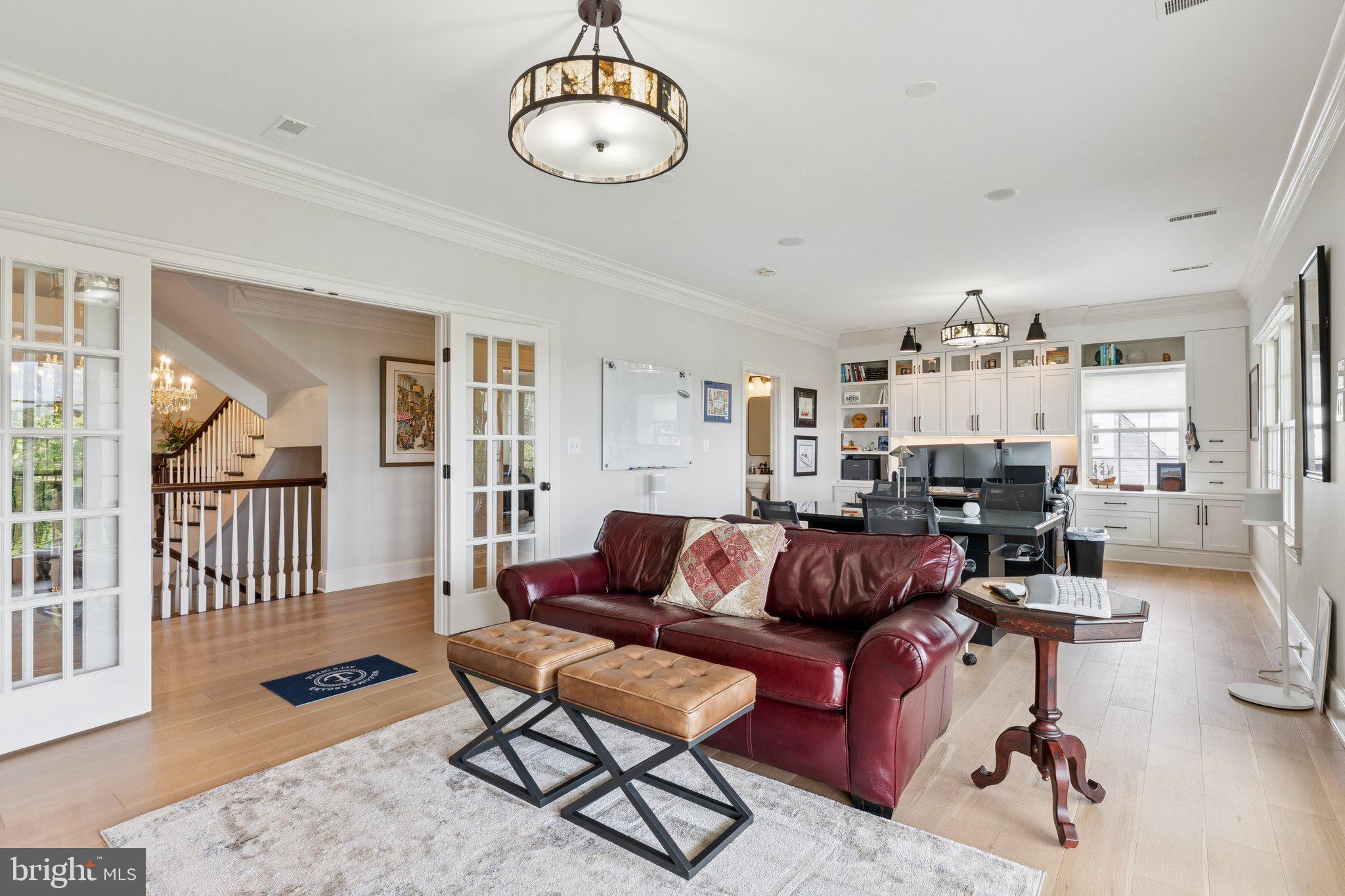 1932 Carrollton Road Annapolis, MD 21409 - Photo 39 of 85 a living room with furniture a wooden floor and a chandelier