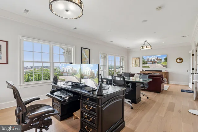 a view of a house with a large window and wooden fence