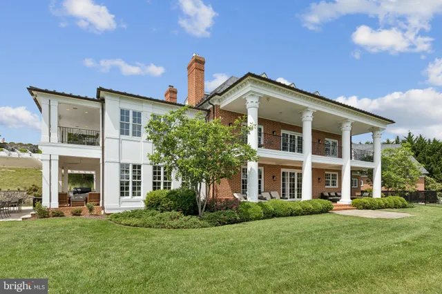 a living room with furniture a fireplace and a large window