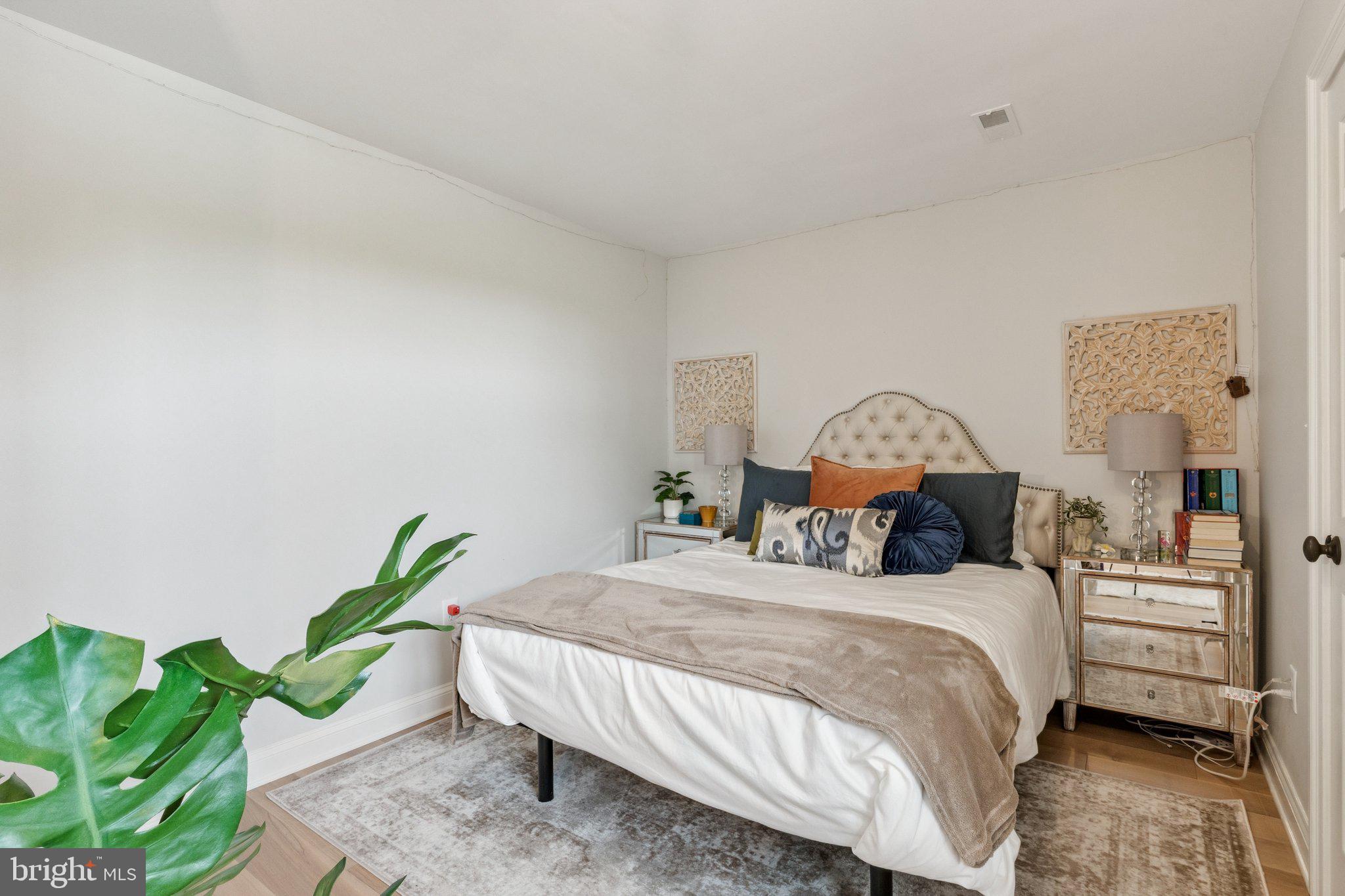 1932 Carrollton Road Annapolis, MD 21409 - Photo 49 of 85 a bedroom with a bed a couch and a potted plant on the dresser