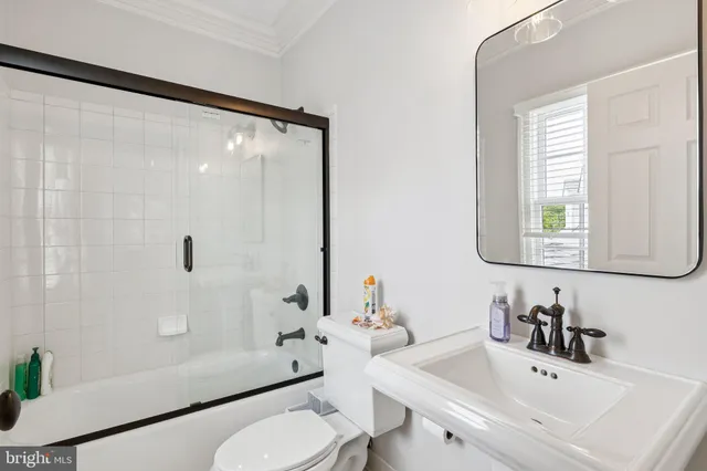 an aerial view of a house with a yard and lake view