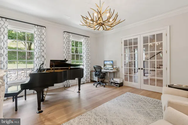a living room with furniture a fireplace and a dining table with wooden floor