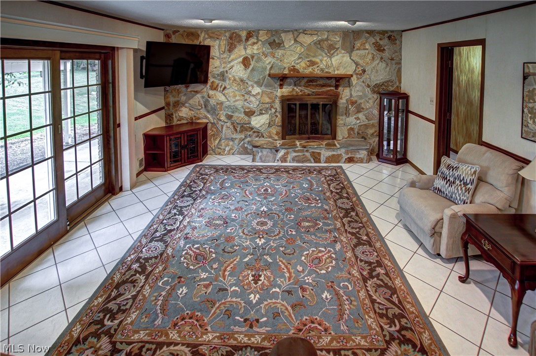 6013 Rousseau Drive Parma, OH 44129 - Photo 9 of 50 Family room with tile flooring, a fireplace, and a textured ceiling