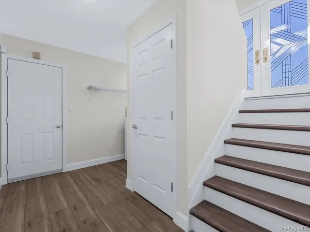 a view of an entryway with wooden floor