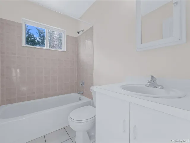 a bathroom with a sink a toilet and bathtub