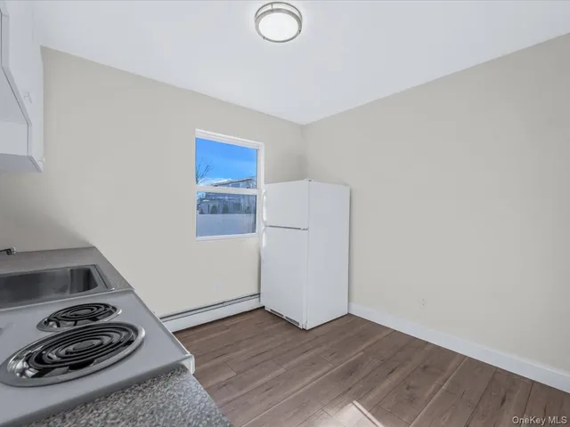 a view of a storage and utility room with wooden floor