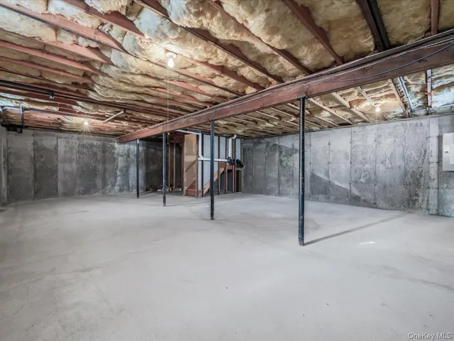 a view of empty room with wooden walls