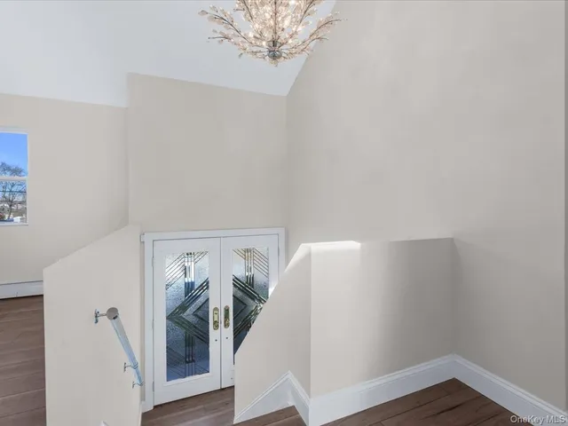 a view of a room with wooden floor and hallway