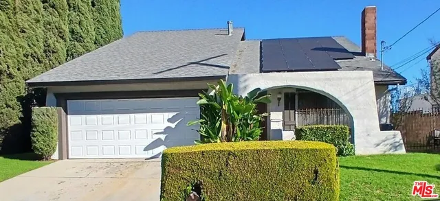 a view of house with garden and plants
